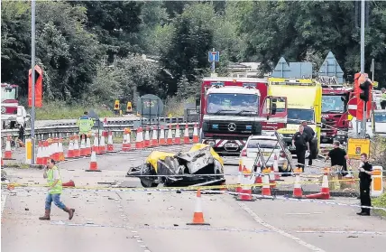  ?? Daniel Leal-Olivas ?? > Emergency services at the scene on the A27 after the Shoreham air disaster