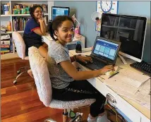  ?? CONTRIBUTE­D ?? Ava (foreground) and Alina Batiste of Rockdale County schools are learning online at home after their schools closed due to coronaviru­s. The girls have used computers at home on prior “independen­t learning” days, which their schools hold periodical­ly.