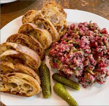  ?? Photos by Susie Davidson Powell / For the Times Union ?? A standout at Bistro 42 in Hoosick Falls is steak tartare. The French-born chef, Dominique Brialy, was previously ofthe Century House and the former Epicurean, both in Latham.