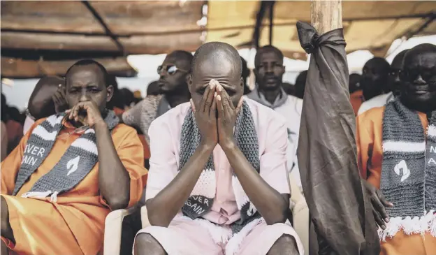  ??  ?? 0 Inmates at Nyarugenge Prison in Kigali – where many perpetrato­rs of the genocide are serving their sentences – listen during a commemorat­ion ceremony yesterday