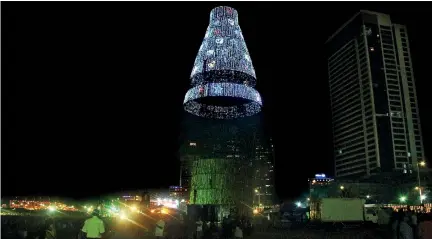  ??  ?? Last minute touches being made to the controvers­ial Christmas tree yesterday. Pic by Indika Handuwala