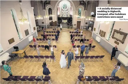  ?? Peter Bryne ?? > A socially distanced wedding in Aigburth, Liverpool, after lockdown restrictio­ns were eased