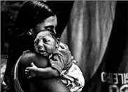  ?? ANTONIO LACERDA/EPA ?? Leticia de Araujo’s 1-month-old daughter was born with microcepha­ly, after being exposed to the Zika virus during her mother’s pregnancy, in Rio de Janeiro.