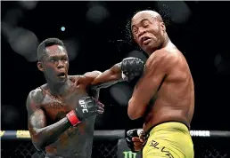  ?? GETTY IMAGES ?? Israel Adesanya, left, had a jibe at Robert Whittaker following his victory over Anderson Silva in Melbourne.