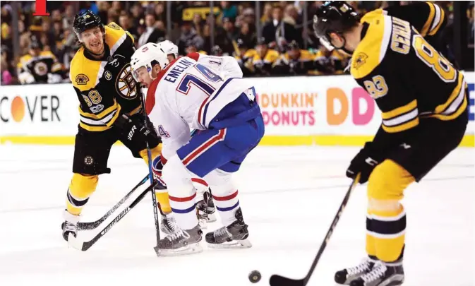  ??  ?? BOSTON: David Pastrnak #88 of the Boston Bruins makes a pass to Peter Cehlarik #83 during the first period against the Montreal Canadiens at TD Garden on Sunday in Boston, Massachuse­tts. — AFP