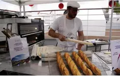  ?? (AP) ?? FRENCH BAKER Tony Dore prepares baguettes, like those that will be served during the. Olympic Games, Tuesday, April 30, 2024 in Paris. Some 40,000 meals will be served each day during the Games to over 15,000 athletes housed at the Olympic village.