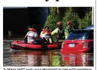  ?? JOE RAEDLE / GETTY IMAGES ?? Ty Mann (left) and Laura Washington ride with members of New York Urban Search and Rescue Task Force One as they are evacuated from their apartments due to flood waters from the Little River on Tuesday in Spring Lake, North Carolina.