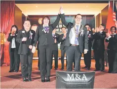  ??  ?? Kevin (right) and his predecesso­r Tiong gesture after the installati­on ceremony. At left is Lee.