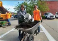  ?? ZACHARY SRNIS — THE MORNING JOURNAL ?? Wellington High School students John Peterson, 16, a sophomore, right, and Justin Yeager, 14, a freshman, work to spread mulch in front of Wellington’s Town Hall.