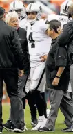  ?? Matthew Stockman / Getty Images ?? Raiders quarterbac­k Derek Carr leaves the game after injuring his back during the third quarter in Sunday’s loss at Denver.