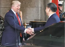  ?? Alex Brandon / Associated Press ?? President Trump greets Chinese President Xi Jinping in Palm Beach, Fla., on April 6. Trump has dropped his pledge to label China a currency manipulato­r.