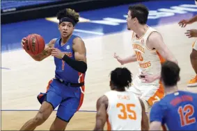  ?? MARK HUMPHREY ?? Florida’s Tre Mann (1) drives against Tennessee’s John Fulkerson (10) in the first half of an NCAA college basketball game in the Southeaste­rn Conference Tournament Friday, March 12, 2021, in Nashville, Tenn.