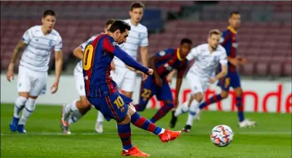  ?? AP Photo/Joan Monfort ?? Barcelona’s Lionel Messi scores a penalty kick during the Champions League group G soccer match between FC Barcelona and Dynamo Kyiv at the Camp Nou stadium in Barcelona, Spain, on Wednesday.