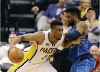 ?? Associated Press ?? ■ Indiana Pacers' Thaddeus Young goes to the basket against Dallas Mavericks' Wesley Matthews during the first half of an NBA basketball game Wednesday in Indianapol­is.