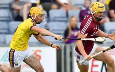  ??  ?? Wexford full-back Darren Byrne trying to keep tabs on Galway’s Seán Bleahene who was re-introduced to score