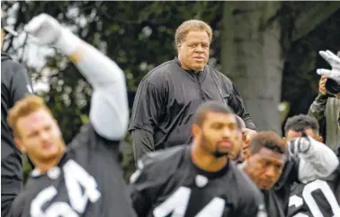  ?? AP PHOTO/JEFF CHIU ?? Reggie McKenzie watches as players stretch during rookie minicamp in Alameda, Calif. McKenzie was fired as general manager of the Oakland Raiders on Monday.