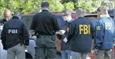  ?? Eric Gay Associated Press ?? FBI AGENTS on Monday near the site of Sunday night’s explosion in Austin, Texas. Authoritie­s said the use of a tripwire in the latest bombing marked a “significan­t change” because it targeted the general public and entailed “a higher level of skill.”