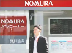  ?? KIYOSHI OTA / BLOOMBERG FILES ?? Nomura Holdings Inc., Japan’s largest brokerage, has announced a new policy that employees are not to smoke
during working hours, even at home.