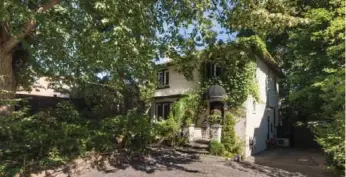  ??  ?? This two-storey, detached, all-brick home has a long flagstone walkway beside a wide interlocki­ng brick driveway.