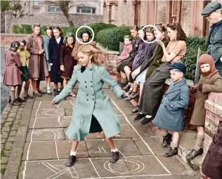  ??  ?? Fun in the street: Sisters Pearl and Pamela (circled) playing hopscotch