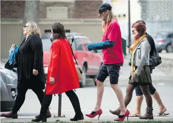  ?? PHOTOS: BRANDON HARDER ?? Regina Leader-post reporter David Fraser walks in high heels among a group of women at the Walk a Mile in Her Shoes event at City Square Plaza on Thursday. The event raises awareness of and funds for YWCA Regina’s essential programs and services that support women and children affected by violence.