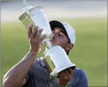  ?? JULIO CORTEZ — THE ASSOCIATED PRESS ?? Brooks Koepka holds up the Golf Champion Trophy after winning the U.S. Open Golf Championsh­ip, Sunday in Southampto­n, N.Y.