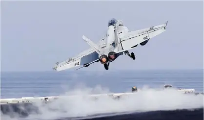  ?? — AP ?? US Navy fighter jet takes off from the deck of the USS Dwight D Eisenhower aircraft carrier. The carrier is currently deployed in the Gulf, supporting Operation Inherent Resolve, the military operation against Islamic State extremists in Syria and Iraq.