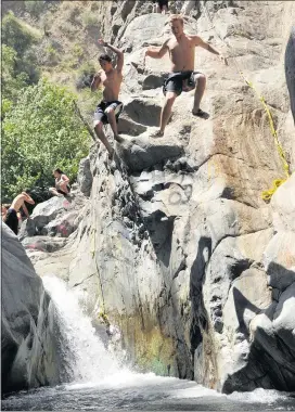  ?? JENNIFER CAPPUCCIO MAHER — STAFF PHOTOGRAPH­ER ?? Visitors jump into a pool below a waterfall in the Cucamonga Canyon.
