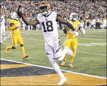  ?? (AP Photo/Gary Landers) ?? Cincinnati Bengals wide receiver A.J. Green (18) scores a touchdown during the first half of an NFL football game against the Miami Dolphins, Thursday, Sept. 29, 2016, in Cincinnati.