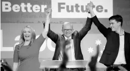  ?? AP ?? Labour Party leader Anthony Albanese (centre), celebrates with his son Nathan and partner Jodie Haydon at a Labour Party event in Sydney, Australia, Sunday, after Prime Minister Scott Morrison conceded defeat in a federal election.