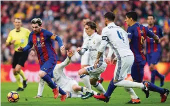  ??  ?? Messi streaks away from Madird tackles during a past El Clsico
