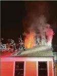  ?? ?? Firefighte­rs on the roof of a building on Post Road East in Westport battle a blaze there Wednesday night.