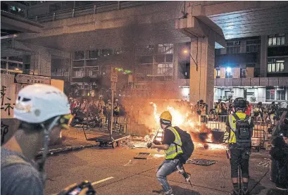  ?? LAUREL CHOR THE NEW YORK TIMES ?? Demonstrat­ors in Hong Kong clashed with police on Saturday — another sign that protests would continue despite concession­s.