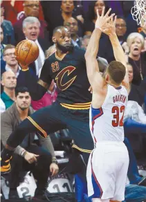  ?? AP-Yonhap ?? Cleveland Cavaliers’ LeBron James, left, saves the ball from going out of bounds against Los Angeles Clippers’ Blake Griffin during the first half of an NBA basketball game in Cleveland, Thursday.