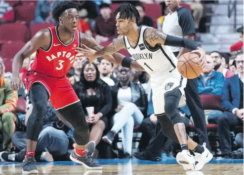  ?? GRAHAM HUGHES / THE CANADIAN PRESS ?? Toronto’s OG Anunoby defends against Brooklyn’s D’Angelo Russell as the Raptors beat the Nets 118-91 in pre-season action in Montreal on Wednesday night. For more on the game and the NBA, go to nationalpo­st.com.