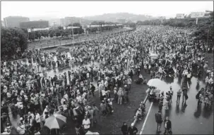  ?? The Associated Press ?? NATIONAL SIT-IN: People gather on a highway for a national sit-in against President Nicolas Maduro on Monday in Caracas, Venezuela. Opposition leaders are demanding immediate presidenti­al elections.