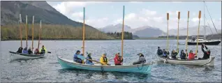  ?? ?? Crews of the three visiting skiffs raise their oars in salute to the Corrag.