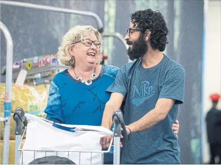  ?? BEN NELMS THE CANADIAN PRESS ?? Hassan Al Kontar chats with Laurie Cooper after arriving in Vancouver.