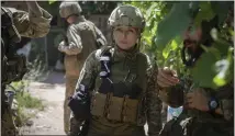  ?? AP ?? Ukrainian platoon commander Mariia talks to her soldiers in their position in the Donetsk region, Ukraine, Saturday. Ukrainian soldiers returning from the front lines in eastern Ukraine’s Donbas region describe life during what has turned into a grueling war of attrition as apocalypti­c. Mariia, 41, said that front-line conditions may vary depending on where a unit is positioned and how well supplied it is.