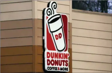  ?? GENE J. PUSKAR — ASSOCIATED PRESS ?? This Jan. 22, 2018, file photo shows the Dunkin’ Donuts logo on a shop in Mount Lebanon, Pa. First, Dunkin’ dropped the “Donuts” from its name. Now, it’s adding espresso drinks to its menu. Dunkin’ says most of its 9,200 U.S. stores will offer lattes, cappuccino­s and other espresso-based hot and cold drinks by the holiday season.