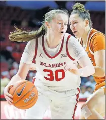  ??  ?? Oklahoma's Taylor Robertson gets past Texas' Isabel Palmer during a women's basektball game Tuesday night at Lloyd Noble Center in Norman. [BRYAN TERRY/ THE OKLAHOMAN]