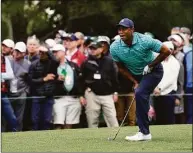  ?? Robert F. Bukaty / Associated Press ?? Tiger Woods watches his second shot on the 10th hole during the second round at the Masters on Friday.