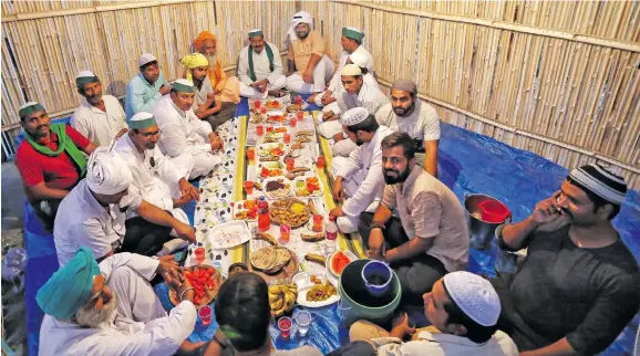  ?? Photo: ANI ?? Farmers break their fast during the holy month of Ramadan during the protest against the three farm laws at Ghazipur Border, in New Delhi on April 15, 2021.