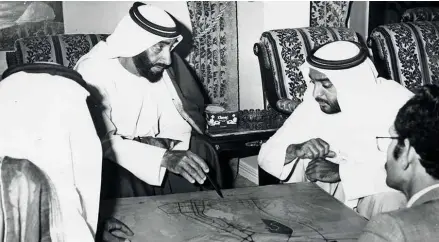  ?? WAM/Gulf News Archives ?? Building roads
Right: Shaikh Khalifa listens as Shaikh Zayed makes a point on the developmen­t of the road system in Abu Dhabi city.