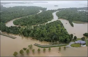  ?? Arkansas Democrat- Gazette/ BENJAMIN KRAIN ?? Water from the Black River pours Thursday through several levee breaks in eastern Pocahontas.