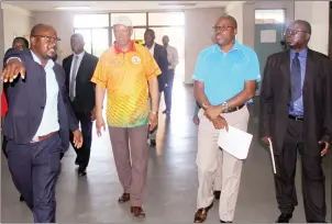  ??  ?? LEADERS ENCLOSURE . . . . (From left) Senior curator of archaeolog­y Happinos Marufu leads the delegation of AUSC Region Five chairman Vetumbuavi Veii and chief executive officer Stanley Mutoya, and Sport and Recreation Commission official Martin Dururu during yesterday’s inspection at the National Sports Stadium