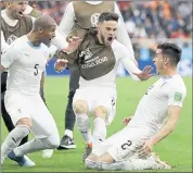  ?? NATACHA PISARENKO — THE ASSOCIATED PRESS ?? Uruguay’s Jose Gimenez, right, celebrates with teammates after scoring the lone goal in a 1-0 win over Egypt on Friday.