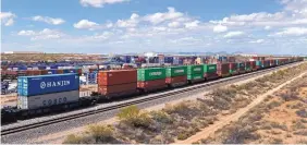  ?? ANDRES LEIGHTON/FOR THE JOURNAL ?? A train transports containers past the facilities of Twin Cities Services Inc. in Santa Teresa, N.M.