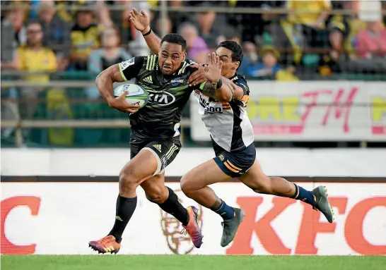  ?? PHOTOSPORT ?? Ngani Laumape beats a tackle to score one of his three tries in the Hurricanes’ impressive 43-13 win over the Brumbies in Palmerston North last night.