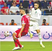  ?? Saudi Arabia’s midfielder Hatan Bahbri fights for the ball with Lebanon’s Joan Oumari. ??